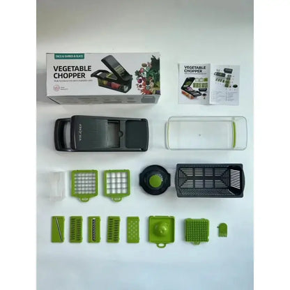Green and black vegetable slicer cutter grater with basket features interchangeable blades and clear collection tray for slicing