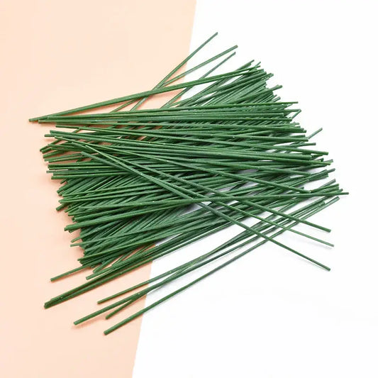 Green artificial flowers iron wire roses stems neatly arranged on two-toned background for wedding decor