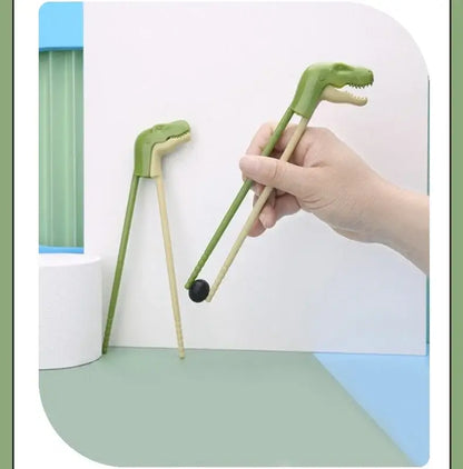 Green dino chopsticks kids training set with wooden handles and plastic dinosaur heads by decorbites for dining room use