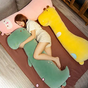Green dinosaur cartoon comfort body pillow with embroidered facial features and pink circular accents plush gift