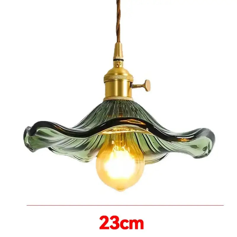 Vintage-style glass pendant light with green wavy shade and polished copper hardware for dining room lighting