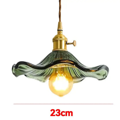 Vintage-style glass pendant light with green wavy shade and polished copper hardware for dining room lighting