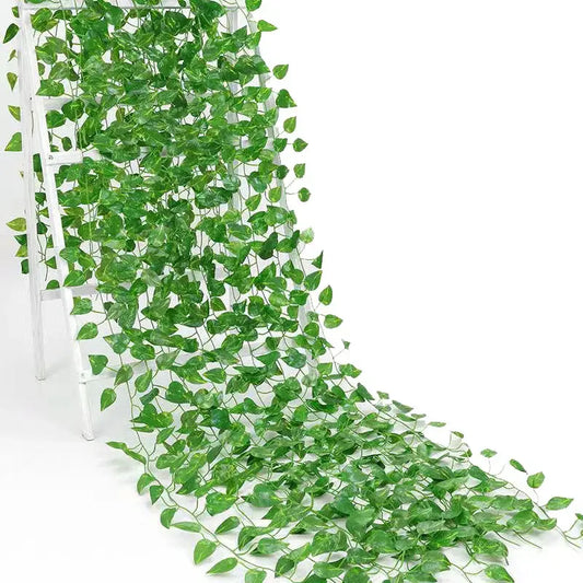 Green silk artificial ivy hanging garland with heart-shaped leaves cascading down a white ladder for decorbites green silk decor