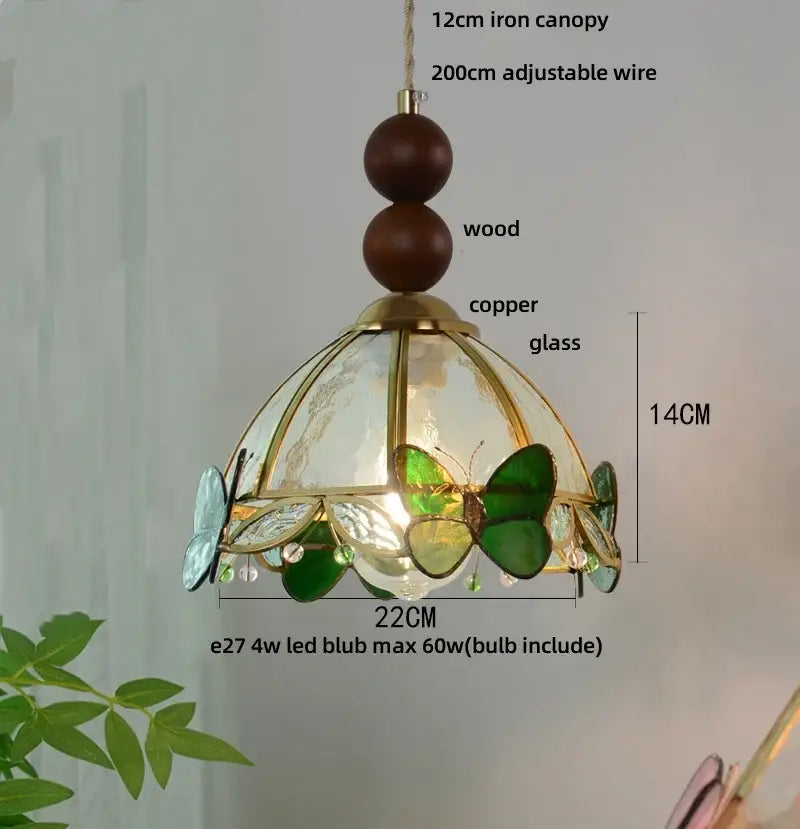 Green stained glass butterfly pendant light featuring brass-finished copper frame decorbites clear glass panels