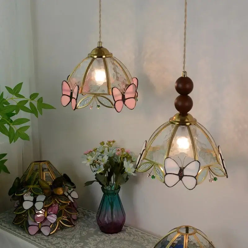 Two hanging stained glass pendant lights with pink and white butterfly motifs brass accents decorbites clear glass led