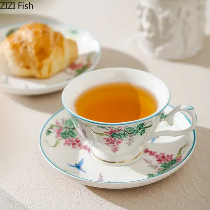 Delicate white porcelain cup and saucer with pink wisteria and green vine flower decorbites green vine accents