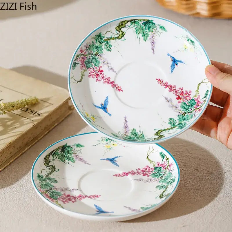 A delicate white ceramic saucer with pink wisteria blossoms, green vines, blue birds, and a turquoise rim for decorbites green vine flower porcelain tea set