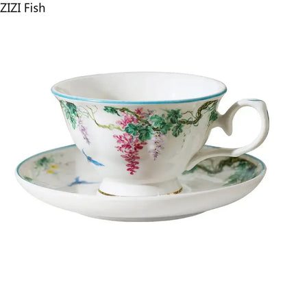 A delicate white vine flower porcelain cup and saucer with pink wisteria blossoms and blue birds from decorbites green vine