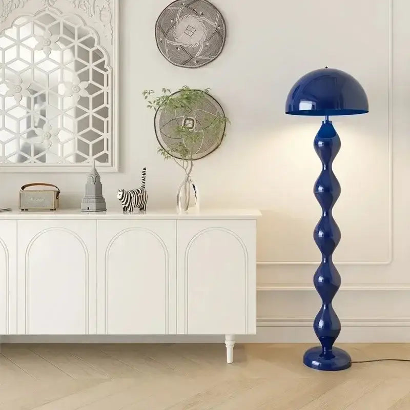 A striking cobalt blue floor lamp with a glossy sculptural base and domed shade for decorbites circle mushroom floor lighting