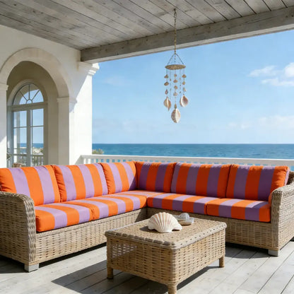 Wicker sectional sofa with orange and purple striped cushions featuring a green and white striped sofa cushion cover protector