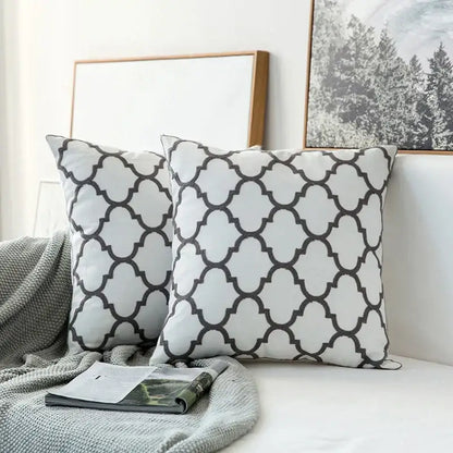 White throw pillows with black quatrefoil pattern in soft fabric grey geometric embroidered cushion cover decorbites gray