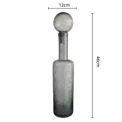 A tall grey round glass decanter with textured hammer lid stopper, 12cm wide by 46cm high for living room decorbites decor