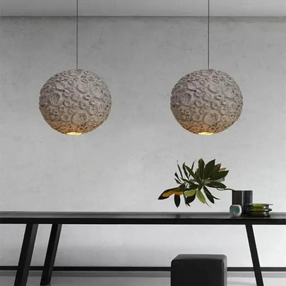 Two spherical off-white matte grey wabi sabi textured pendant lights hang as a wabi sabi chandelier for living room decorbites grey wabi