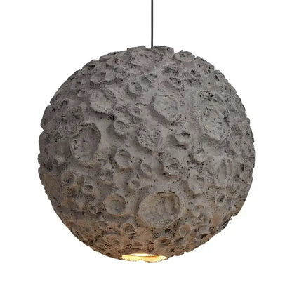 Gray concrete pendant light with textured cratered surface resembling the moon grey wabi sabi chandelier for living room