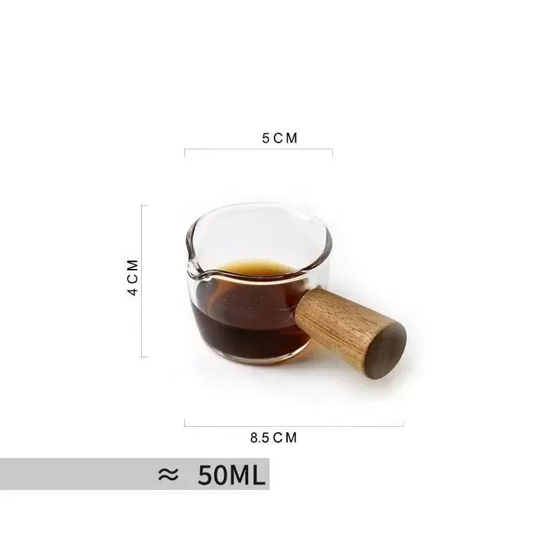 A clear glass guanshan hanging ear coffee cup with wooden handle filled with dark liquid for kitchen drinkware decorbites