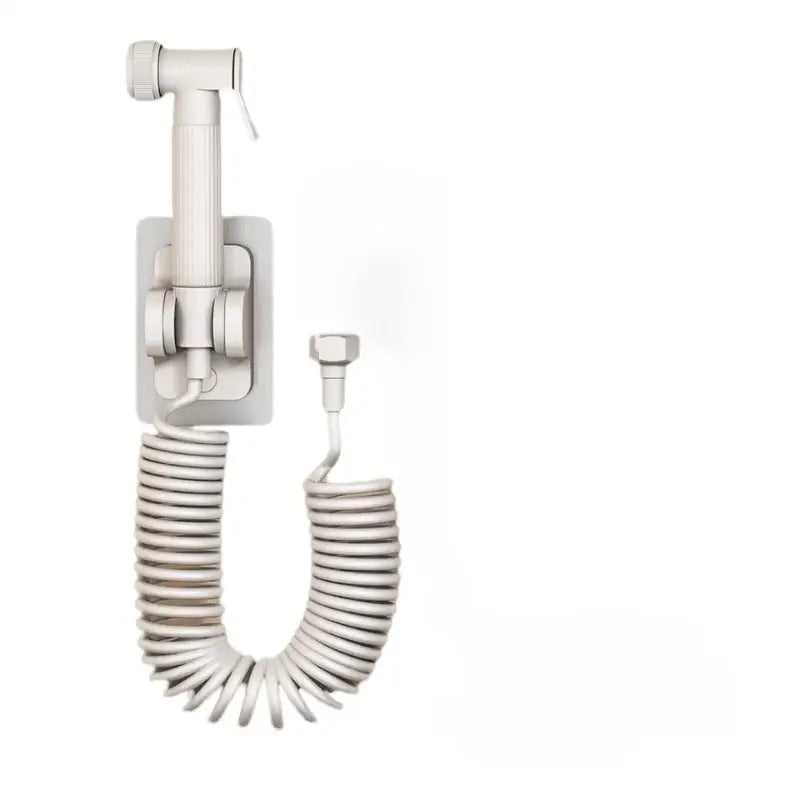 White wall-mounted bidet sprayer with coiled hose and adjustable nozzle in gunmetal gray copper bidet parts set
