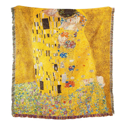 A vibrant yellow woven tapestry bedroom blanket featuring gustav klimt the kiss art pattern with multicolored fringe