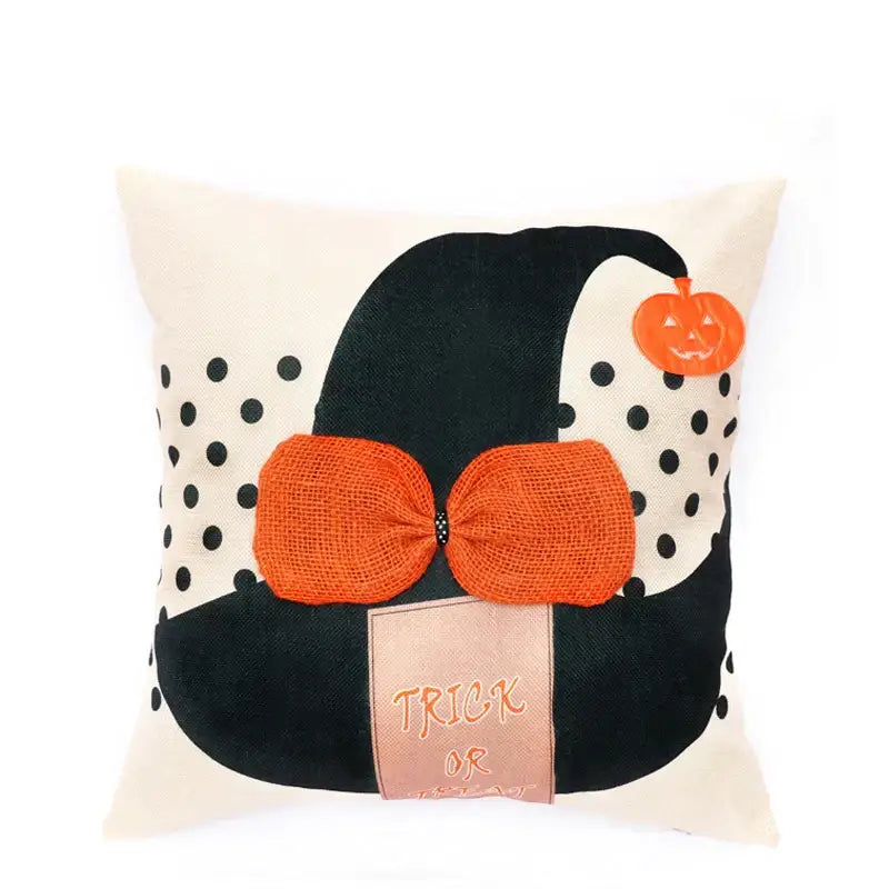 Cream-colored pillow cover featuring a halloween wizard hat with spider embroidered accents and a pumpkin charm