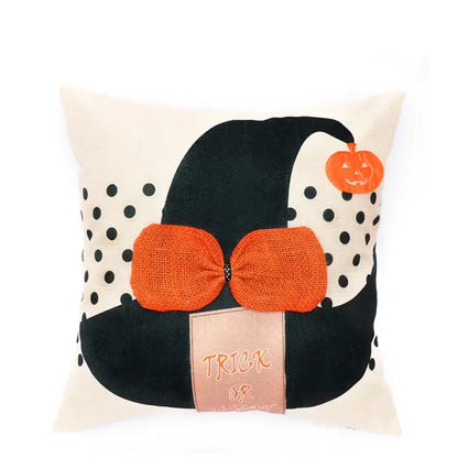 Cream-colored pillow cover featuring a halloween wizard hat with spider embroidered accents and a pumpkin charm