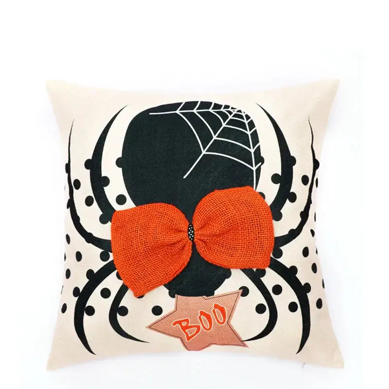 Cream-colored halloween wizard hat pillow cover with spider embroidered design, orange burlap bow, and star boo tag