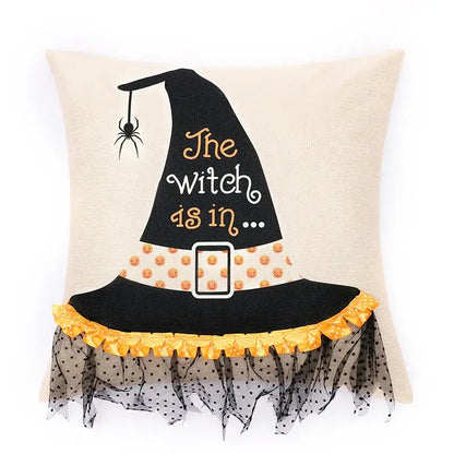 Beige halloween wizard hat pillow cover with black embroidered hat, orange text, spider embroidered design, and ruffled trim