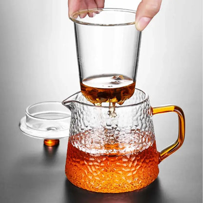 Clear borosilicate glass teapot with a hammered finish and amber handle for a stylish kitchen tea set