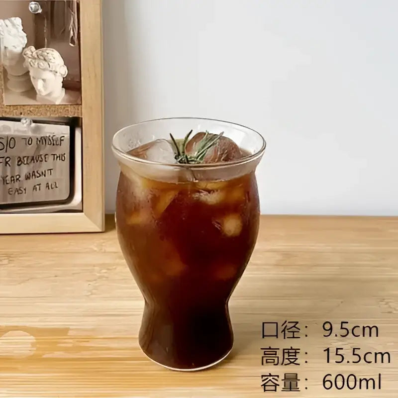Hammered clear glass cafe coffee cup filled with iced coffee garnished with rosemary from decorbites glass cafe