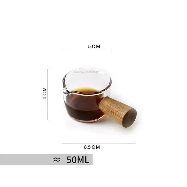 Hammered clear glass cafe coffee cup with wooden handle filled with dark liquid by decorbites glass cafe