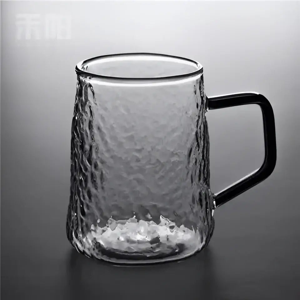 Clear glass mug with hammered finish and black handle complementing decorbites gray amber water pitcher