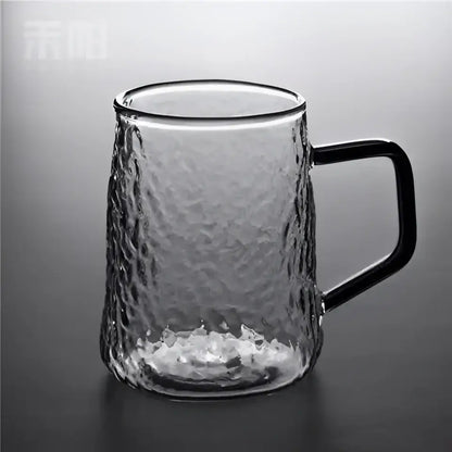 Clear glass mug with hammered finish and black handle complementing decorbites gray amber water pitcher