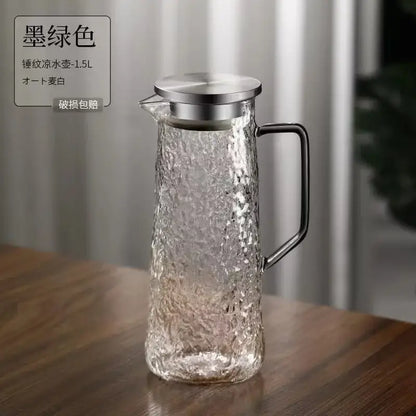 A textured ink green glass water pitcher with metallic lid and handle from decorbites gray amber collection for dining