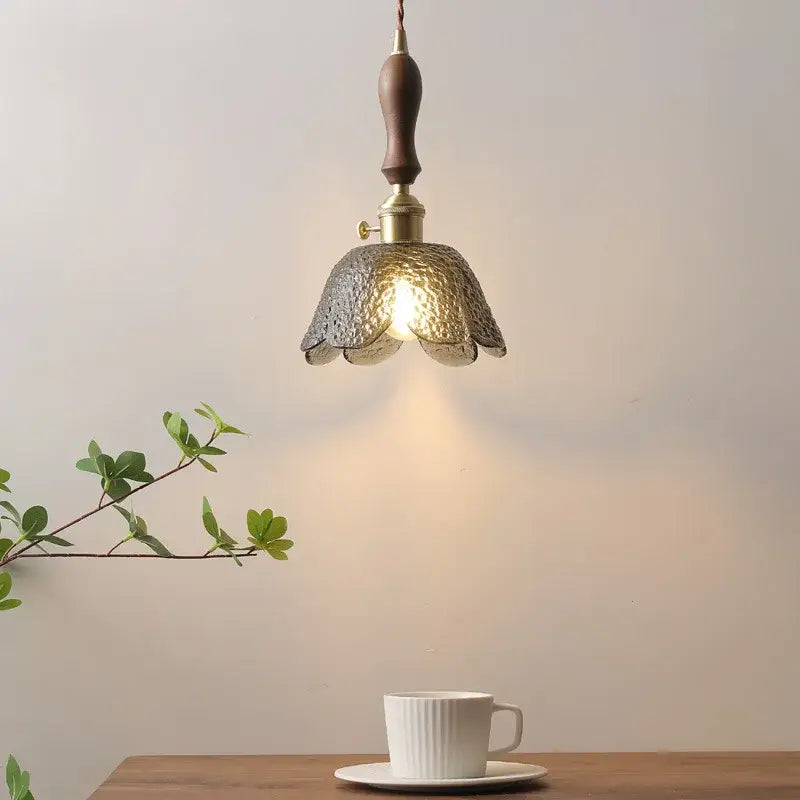 A warm-toned hammered gray glass led pendant lamp with dark wood handle for living room lighting