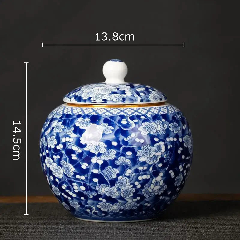 Hand-painted floral white porcelain tea canister with blue and white patterns and gold trim for kitchen storage