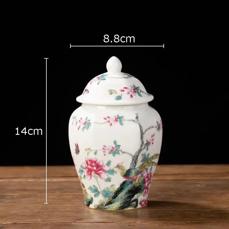 White porcelain tea canister with hand-painted pink green and gold floral and bird motifs for kitchen storage