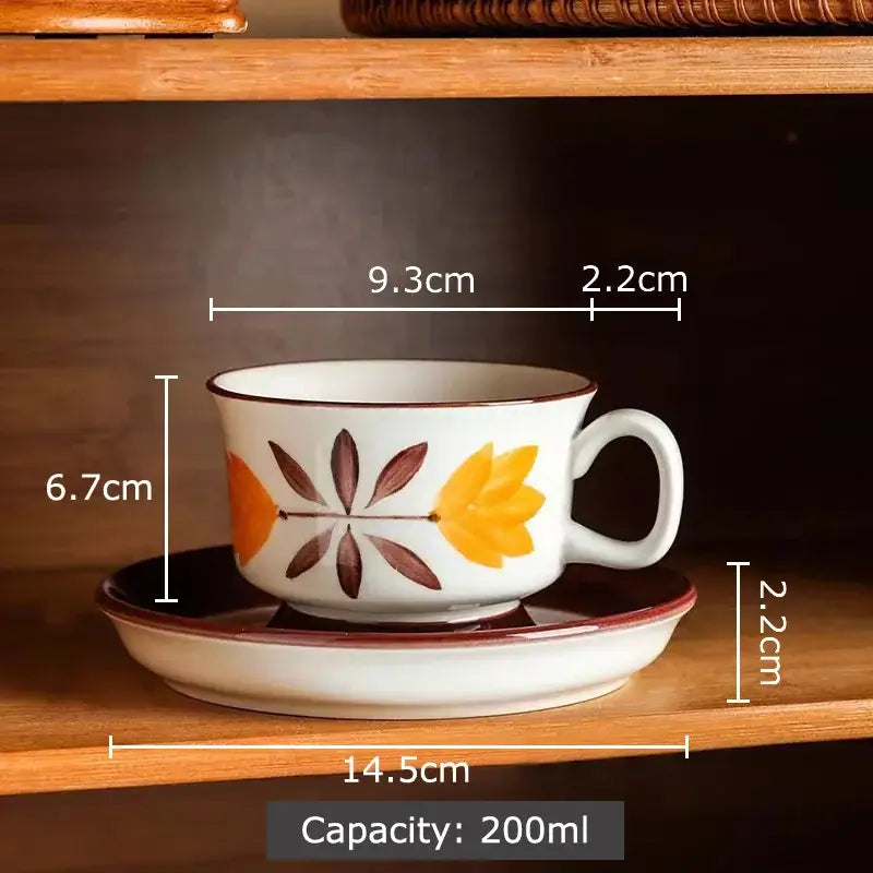 White ceramic teacup with orange and brown autumn leaves hand-painted flowers pattern on matching saucer decorbites flowers pattern