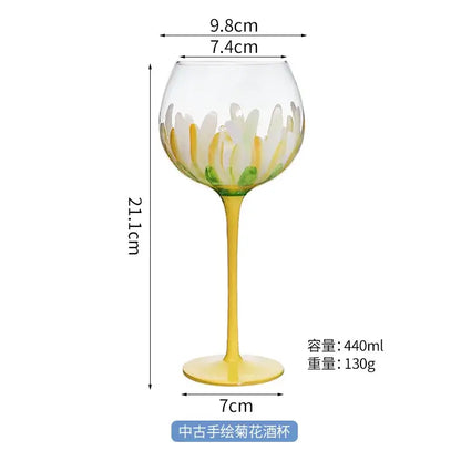 Hand painted glass goblet with yellow stem and base featuring white and yellow daisy petals for floral decor