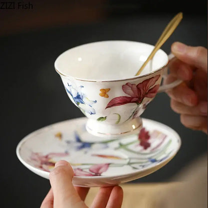 A delicate white porcelain tea cup and saucer featuring hand painted iris flower decorbites iris flower design with gold rim