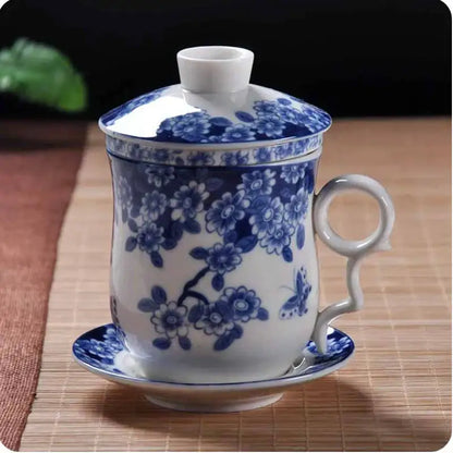 Hand painted lotus white porcelain tea cup with filter featuring blue floral pattern and elegant curved handle for dining room