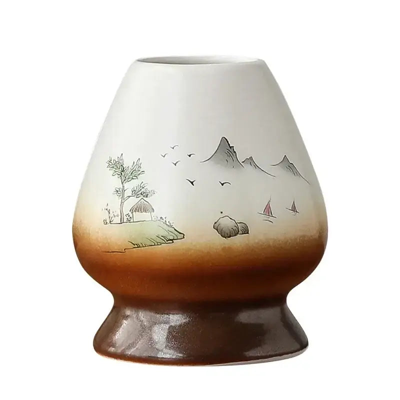 Hand painted white and brown ceramic matcha whisk holder stand with delicate landscape scenes of mountains birds and sailboats