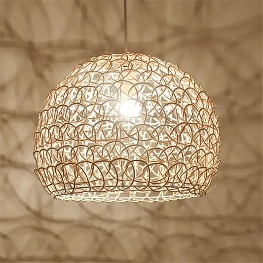A warm-toned spherical hand woven rattan pendant light with intricate circular pattern for modern living room chandelier