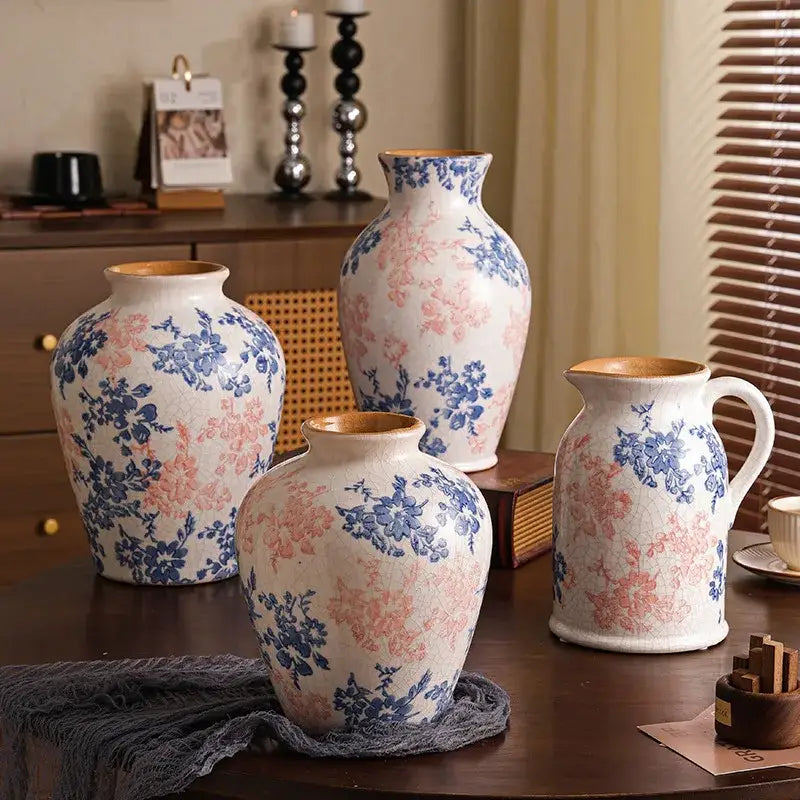 Set of four handcrafted white ceramic vases with blue and pink floral patterns and crackled glaze for decorbites decor