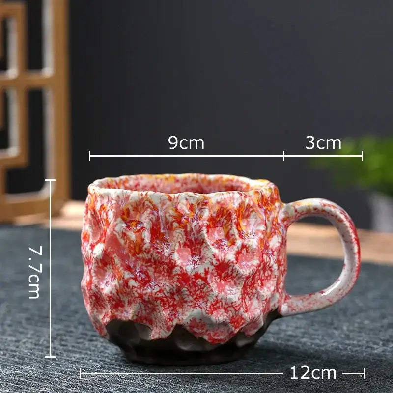 Handcrafted ceramic mug with red and white marbled glaze featuring textured surface in a blue and red hammer pattern ceramic mug set