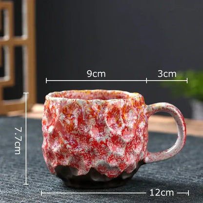 Handcrafted ceramic mug with red and white marbled glaze featuring textured surface in a blue and red hammer pattern ceramic mug set