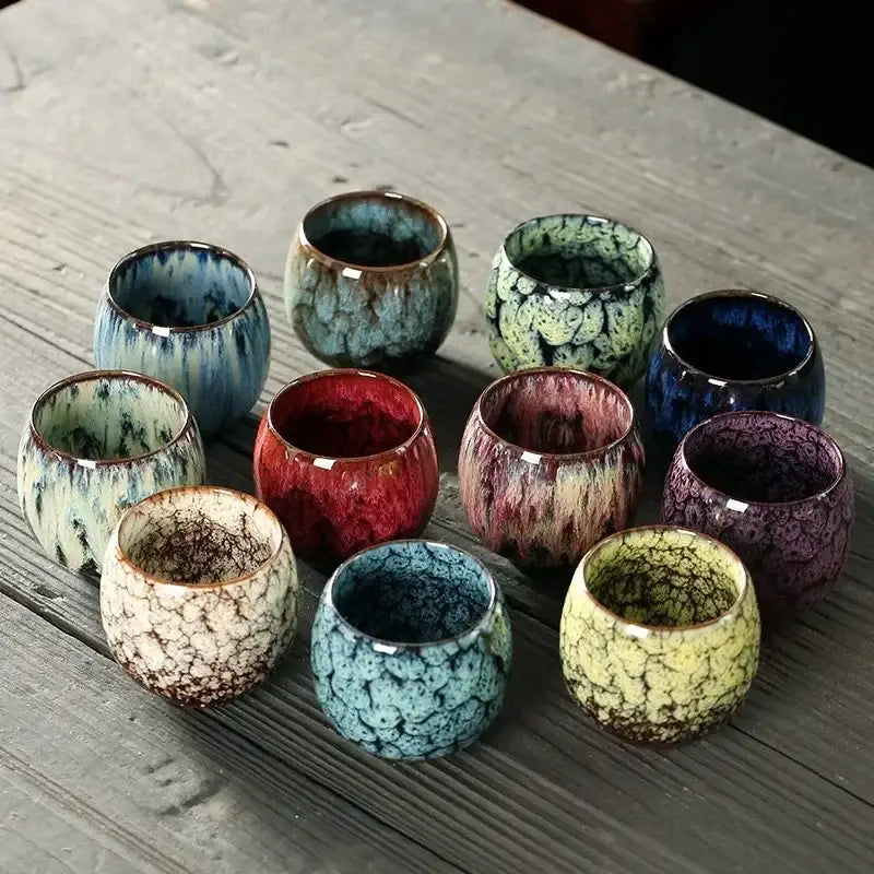 A handcrafted crackle glaze ceramic kung fu tea cup set featuring vibrant red blue green and yellow colors for dining room use