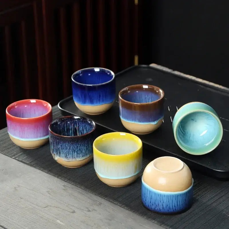 Set of six handcrafted ceramic kung fu tea cups with vibrant gradient glazes in blue yellow red and brown decorbites ceramic kung