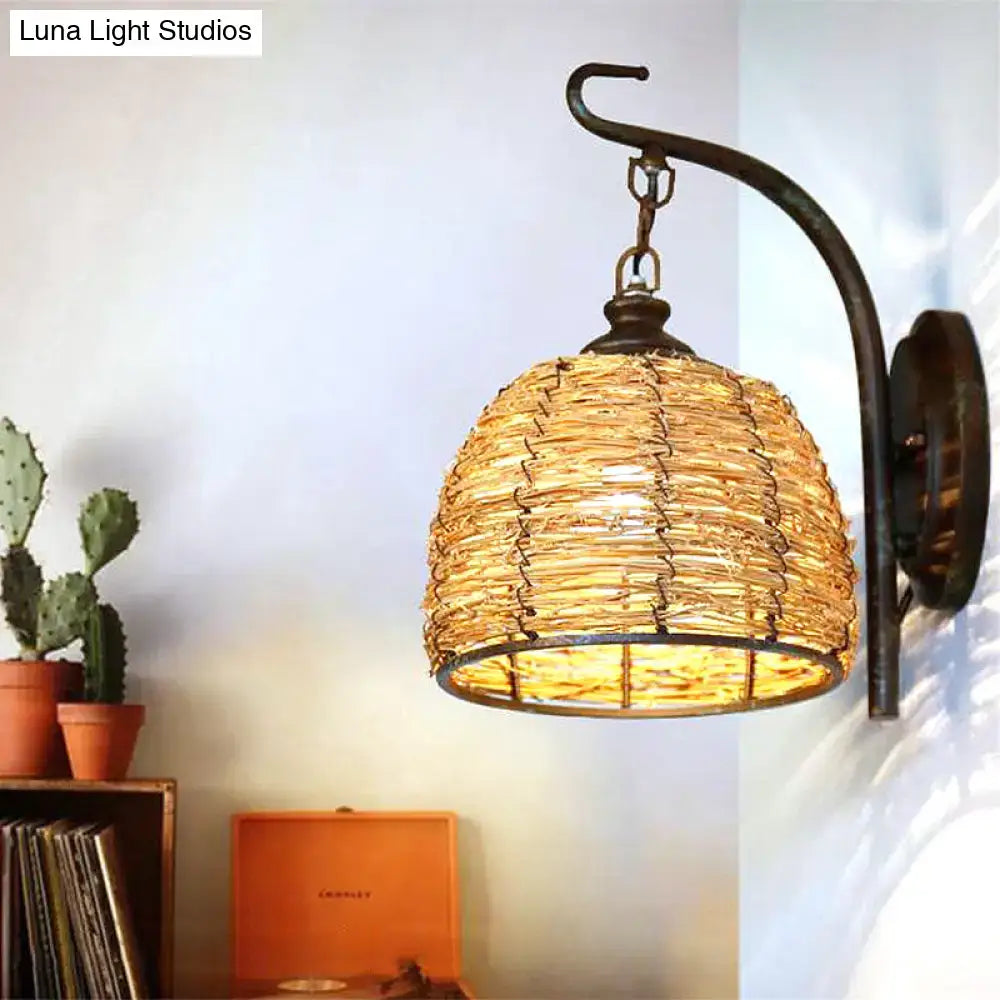 Handmade asian rattan dome wall sconce with woven natural fiber shade and dark bronze curved wrought iron arm fixture type