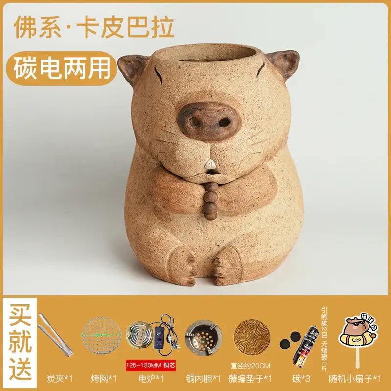 Tan ceramic pig-shaped incense burner with dark brown nose and clasped hands for refractory carbon oven surrounding stove use