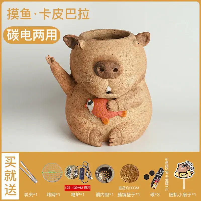 Tan ceramic capybara-shaped carbon oven surrounding stove and electric refractory carbon oven holding orange fish