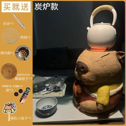 Handmade white ceramic teapot with woven handle on a pig-shaped refractory carbon oven surrounding stove for tea warming