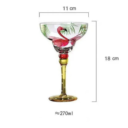 Handmade colorful margarita glass with pink flamingo and green palm leaf design on clear glass with gold stem and base